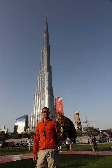 Jacques-Olivier in front of the burj khalifa tower with a white-tailed eagle in focus.