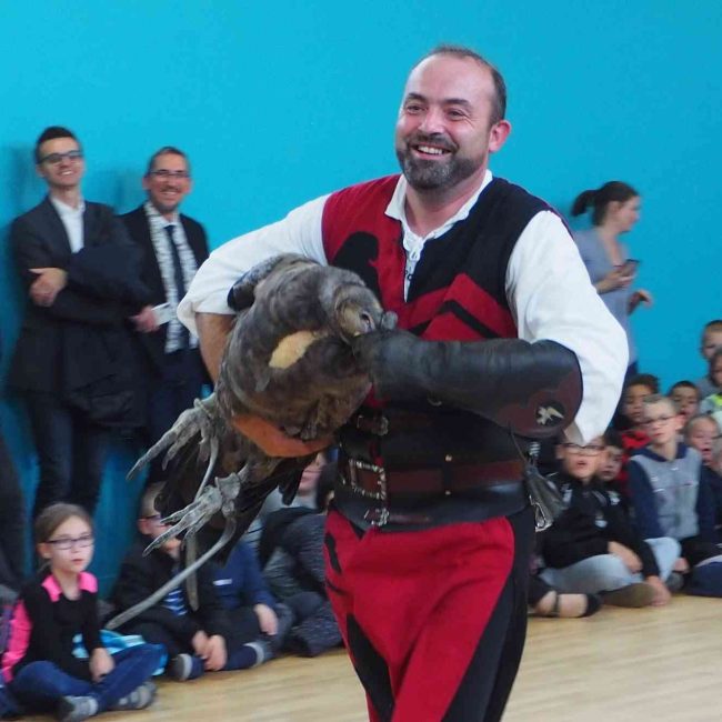 Prestation en costume médiéval montrant un fauconnier portant un condor.