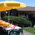 Photo of a birthday table being set up and ready to receive guests. The colours are red and yellow.